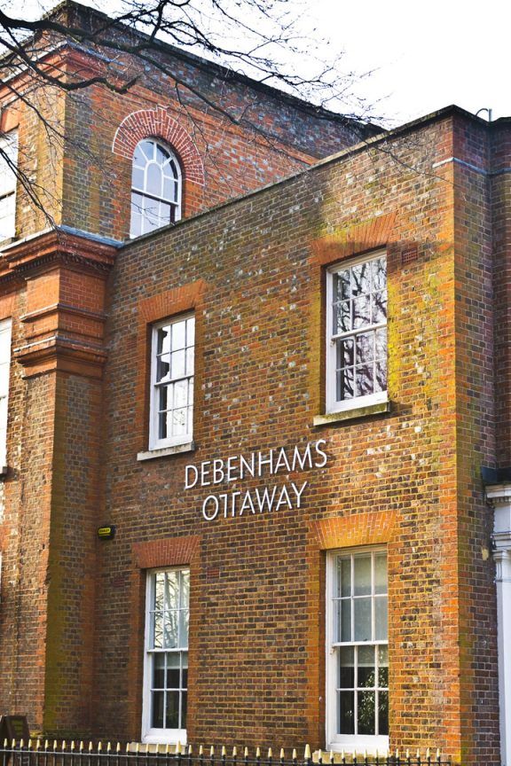 An exterior view of Debenhams Ottaway, a yellow brick building with sash windows.