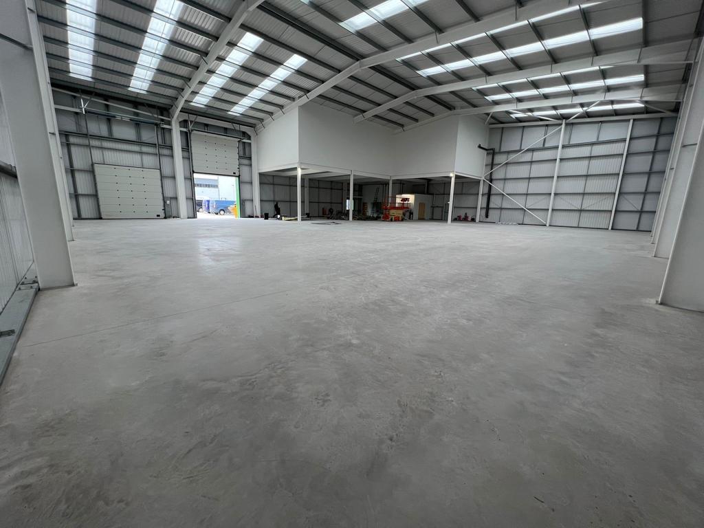 An internal view of a large, empty warehouse.