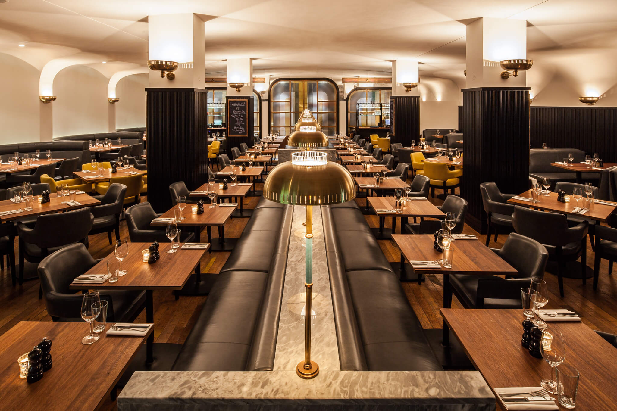 An empty restaurant with tables and chairs for dining.