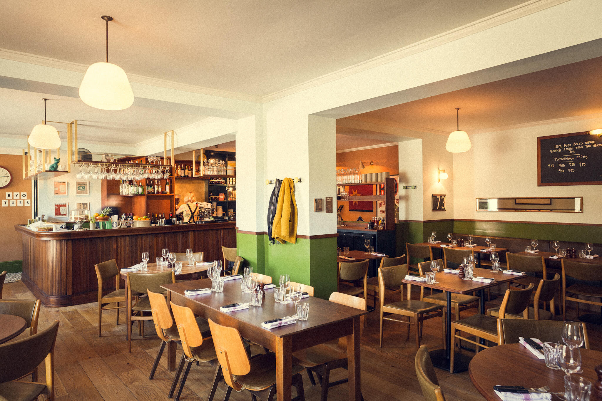 An empty bar with tables and chairs for dining.