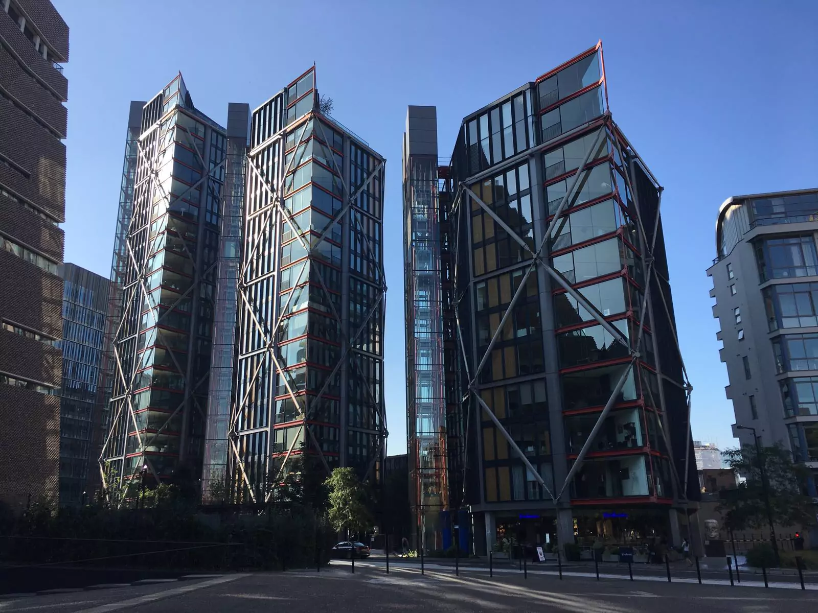 Tall, glass-fronted properties in a city.