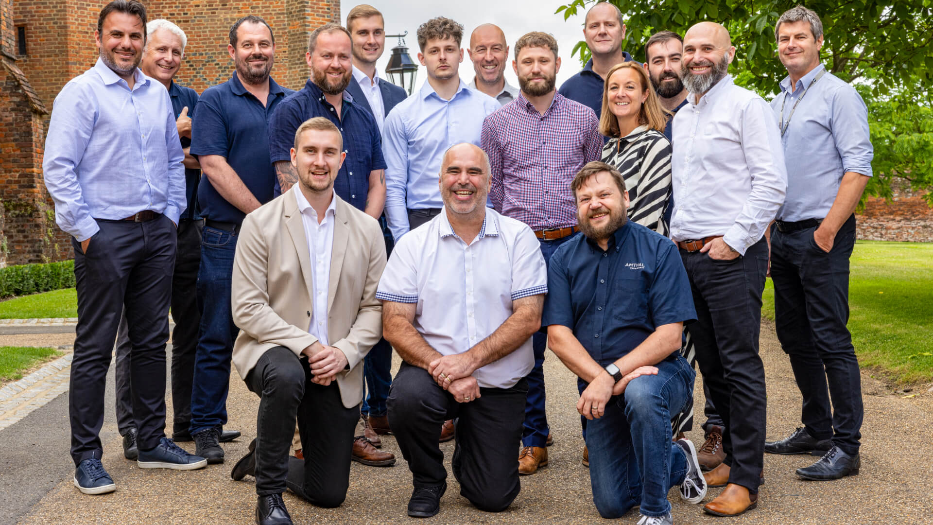 A group of Amthal's senior staff smiling and posing for an official photo.
