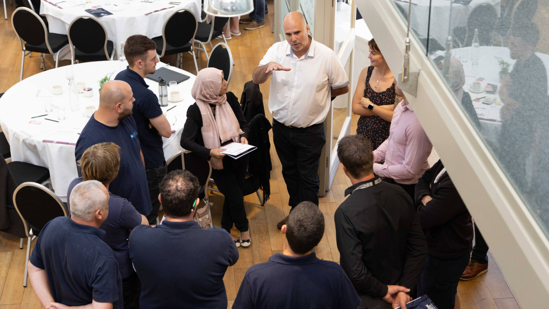 Amthal workers chatting with each other during a meeting.